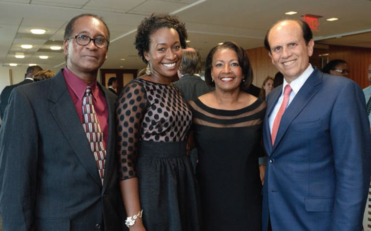 Dr. Joelle Simpson with her parents, Ronald and Marilyn, and Michael Milken