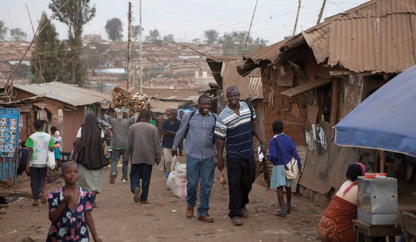 Odede and SHOFCO Programs Director George Okewa walking in Kibera. (Photo: Paul Horton)